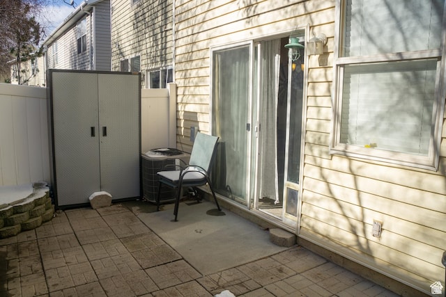 view of patio with fence and central AC unit
