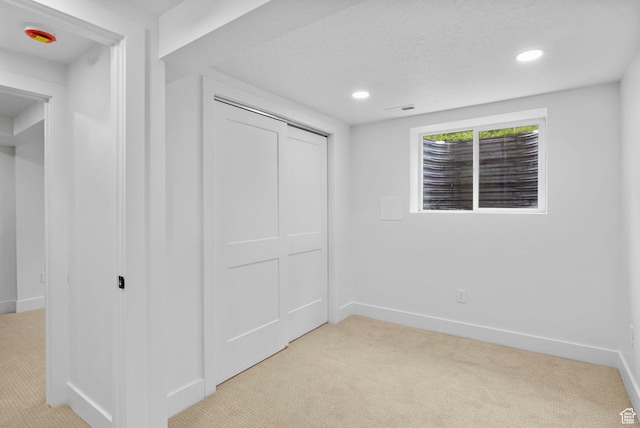 unfurnished bedroom featuring light colored carpet and baseboards