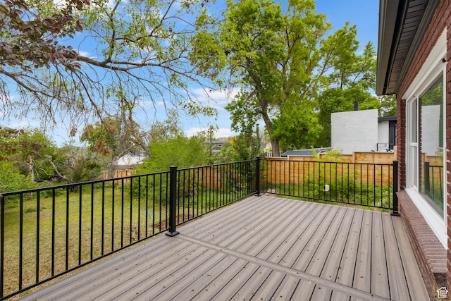 wooden deck with a lawn