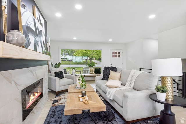 living room with a premium fireplace and recessed lighting
