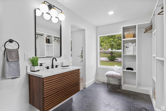 bathroom with vanity and baseboards