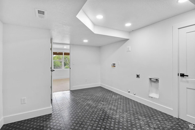 unfurnished room featuring a textured ceiling, baseboards, visible vents, and recessed lighting