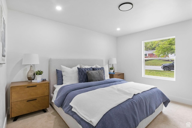 bedroom with light colored carpet, baseboards, and recessed lighting