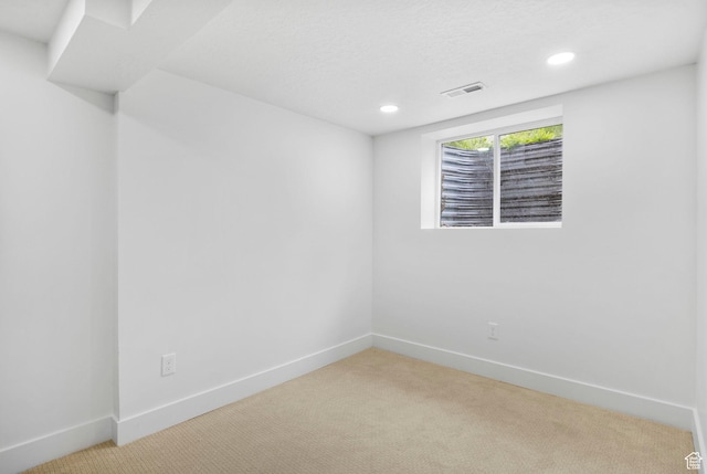 spare room with recessed lighting, visible vents, and light colored carpet