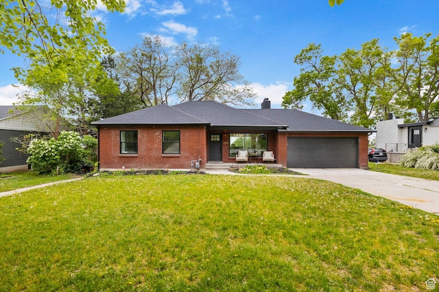 view of front facade with an attached garage, covered porch, concrete driveway, a front yard, and brick siding