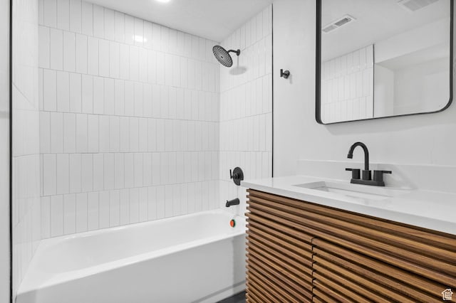 bathroom with  shower combination, vanity, and visible vents