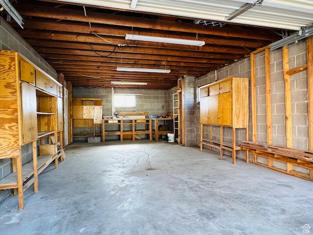 miscellaneous room with concrete floors and concrete block wall