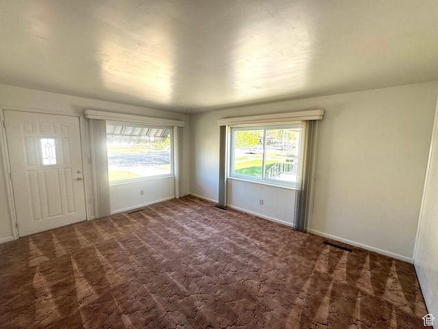 empty room with carpet floors and baseboards