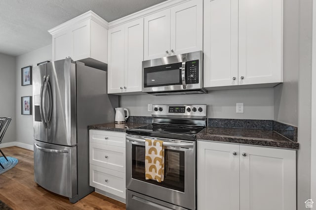 4455 W Glendon Dr, Lehi, UT 84043 - kitchen featuring dark wood finished floors, a textured ceiling, white cabinets, and appliances with stainless steel finishes
