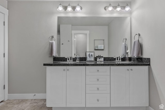 4455 W Glendon Dr, Lehi, UT 84043 - bathroom featuring double vanity, baseboards, and a sink