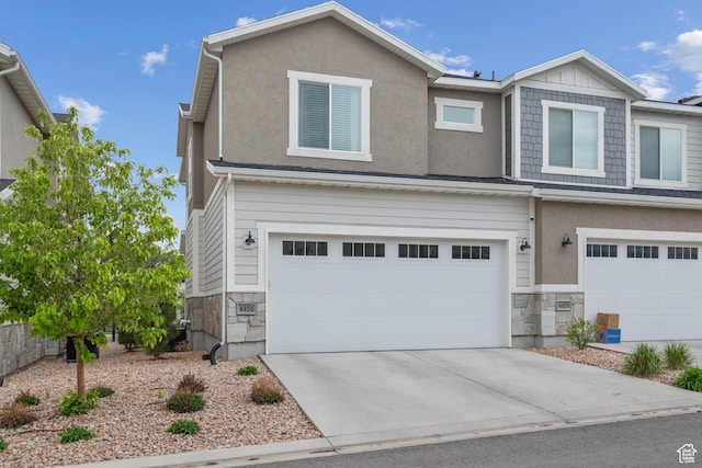 4455 W Glendon Dr, Lehi, UT 84043 - view of front of home with concrete driveway, an attached garage, and stone siding