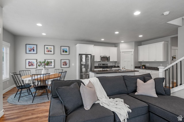 4455 W Glendon Dr, Lehi, UT 84043 - living area with stairway, baseboards, light wood-type flooring, and recessed lighting