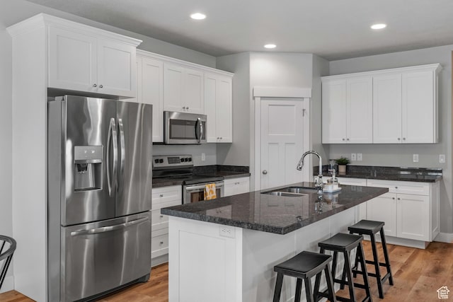 4455 W Glendon Dr, Lehi, UT 84043 - kitchen featuring white cabinets, light wood-style floors, appliances with stainless steel finishes, and a sink