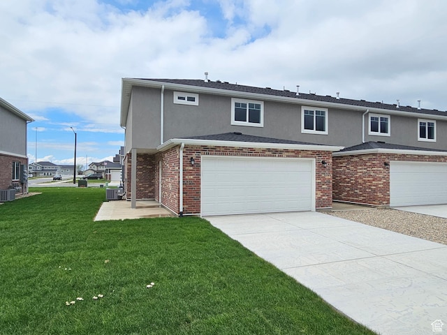 518 N 1400 W Lot 26, Springville, UT 84663 - view of front of house with a garage, central air condition unit, stucco siding, concrete driveway, and a front lawn