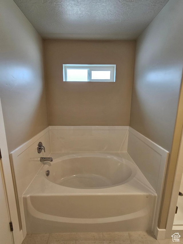 518 N 1400 W Lot 26, Springville, UT 84663 - bathroom featuring tile patterned flooring, a textured ceiling, and a garden tub