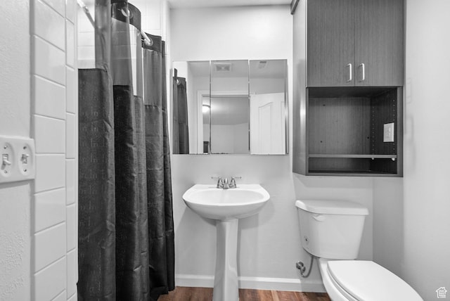 3470 W Maynard Ct, Riverton, UT 84065 - full bathroom with toilet, wood finished floors, a shower with curtain, a sink, and baseboards