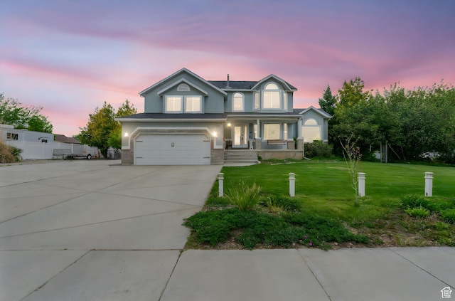 3470 W Maynard Ct, Riverton, UT 84065 - traditional home featuring driveway, a garage, stucco siding, a front yard, and a porch