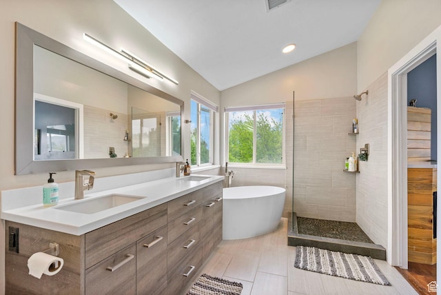 3470 W Maynard Ct, Riverton, UT 84065 - bathroom with lofted ceiling, a freestanding bath, a sink, and a walk in shower