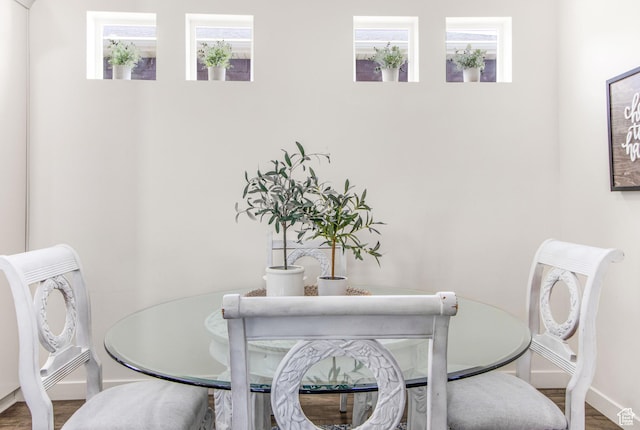 dining room featuring wood finished floors and baseboards