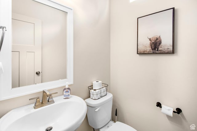 bathroom with toilet and a sink