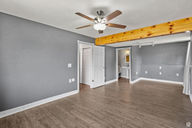 empty room with baseboards, a ceiling fan, and wood finished floors