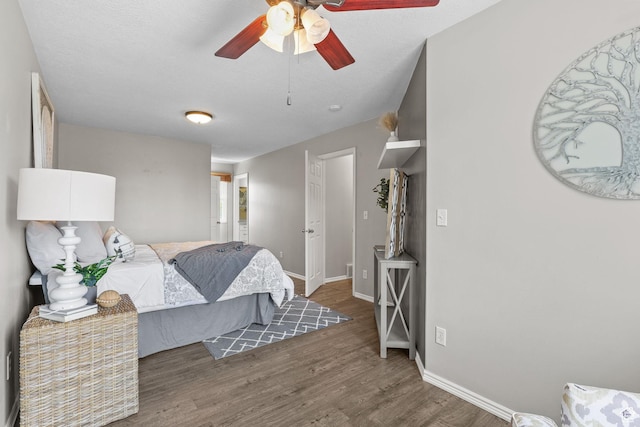 bedroom featuring baseboards, a ceiling fan, and wood finished floors