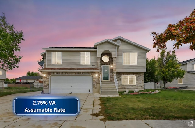 view of front of home featuring a front lawn, driveway, an attached garage, and fence