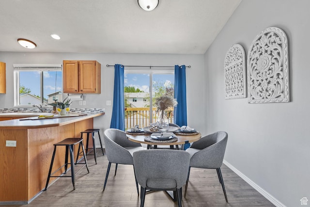 dining area featuring baseboards, recessed lighting, and wood finished floors