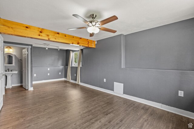 interior space featuring baseboards, wood finished floors, and a ceiling fan