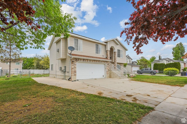traditional-style home with concrete driveway, stone siding, a front lawn, and a garage