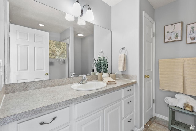 full bathroom featuring baseboards, vanity, and curtained shower