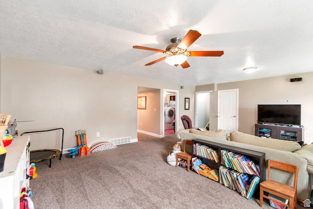 game room featuring carpet floors, visible vents, baseboards, ceiling fan, and washer / clothes dryer