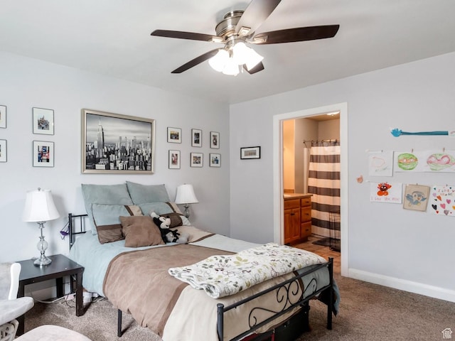 carpeted bedroom with connected bathroom, baseboards, and ceiling fan
