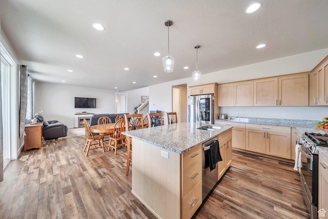 2882 S Allison Way W, Syracuse, UT 84075 - kitchen featuring light brown cabinets, appliances with stainless steel finishes, open floor plan, wood finished floors, and recessed lighting