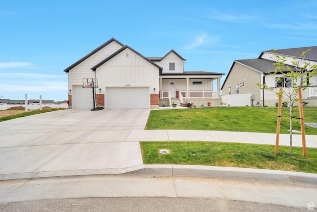 2882 S Allison Way W, Syracuse, UT 84075 - view of front of home featuring brick siding, a garage, covered porch, a front yard, and driveway
