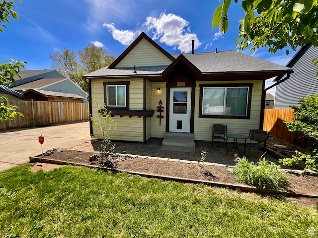 2610 S 8000 W, Magna, UT 84044 - bungalow featuring a front lawn, a patio area, and fence