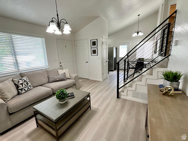 2610 S 8000 W, Magna, UT 84044 - living room featuring light wood-type flooring, a chandelier, lofted ceiling, and stairway