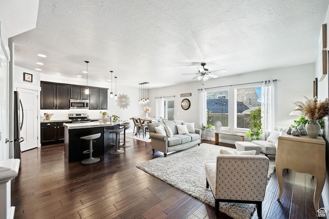 1559 W 430 N, Lindon, UT 84042 - living area with a textured ceiling, dark wood-type flooring, a ceiling fan, and recessed lighting