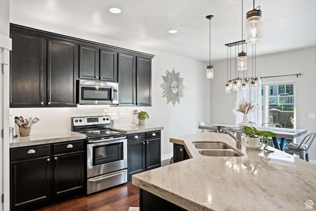 1559 W 430 N, Lindon, UT 84042 - kitchen featuring stainless steel appliances, dark cabinets, a sink, and dark wood-type flooring