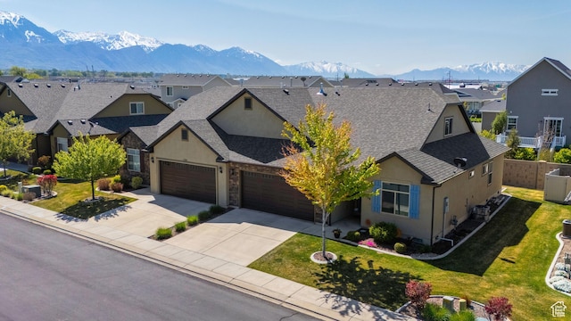 1559 W 430 N, Lindon, UT 84042 - traditional-style home featuring a mountain view, a residential view, stucco siding, roof with shingles, and driveway