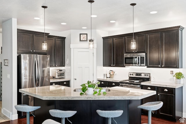 1559 W 430 N, Lindon, UT 84042 - kitchen with a breakfast bar, dark brown cabinetry, stainless steel appliances, and decorative backsplash