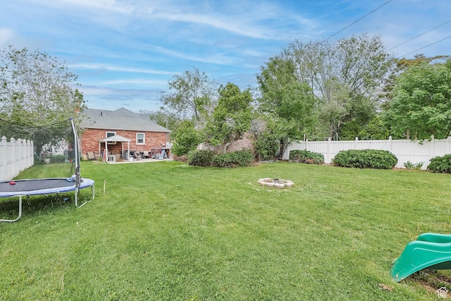 173 W 300 N, Bountiful, UT 84010 - view of yard featuring a trampoline, an outdoor fire pit, and a patio area