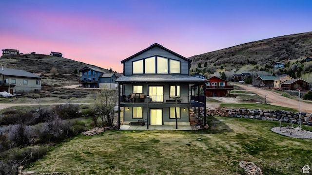 1504 N Sculpin Loop, Garden City, UT 84028 - rear view of house with a patio, a deck with mountain view, and a lawn