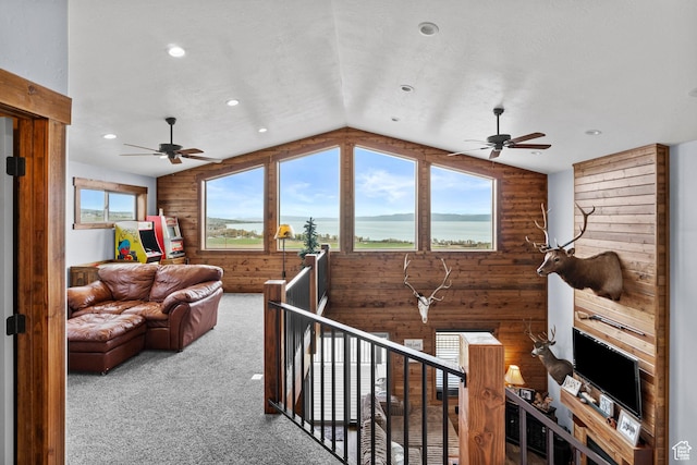 1504 N Sculpin Loop, Garden City, UT 84028 - carpeted living area with a ceiling fan, wooden walls, and vaulted ceiling