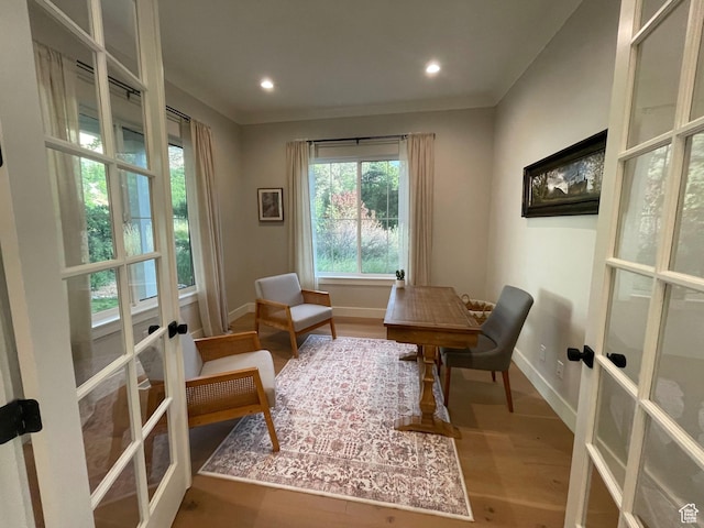 sitting room featuring french doors, baseboards, wood finished floors, and recessed lighting