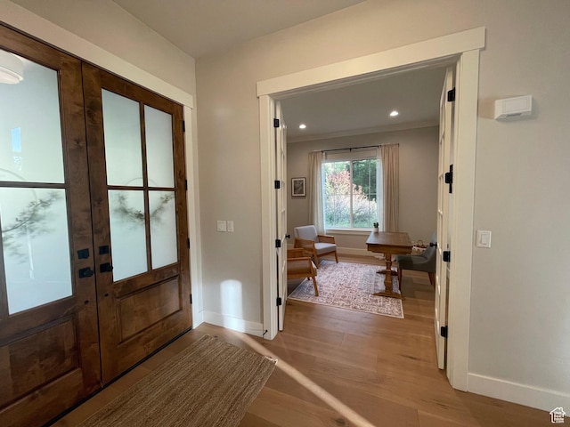 doorway to outside featuring french doors, baseboards, light wood-style flooring, and recessed lighting