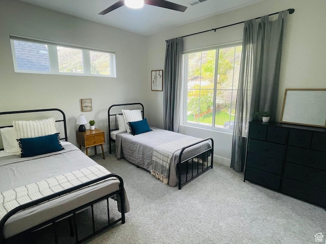 bedroom featuring visible vents, ceiling fan, and carpet floors