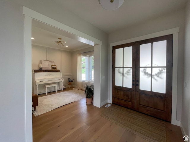 entryway with french doors, wood finished floors, baseboards, and recessed lighting