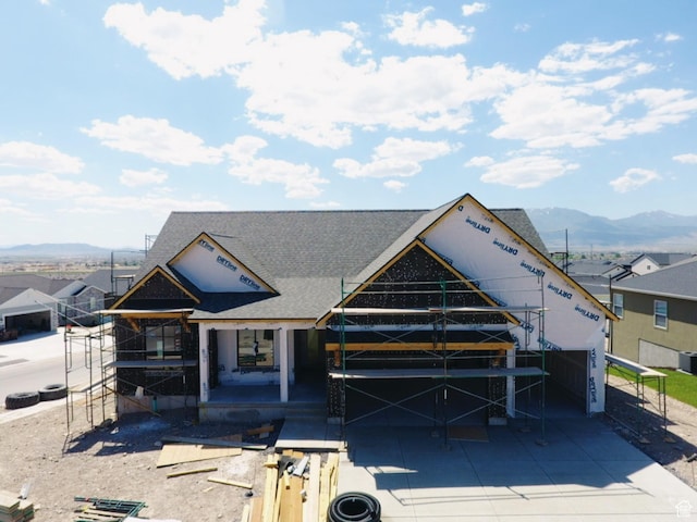 4047 N Ophir Dr, Eagle Mountain, UT 84005 - view of front of house with a shingled roof, a mountain view, and concrete driveway