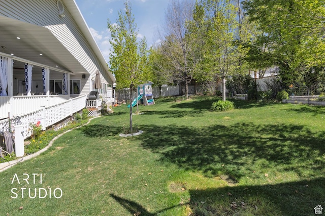 view of yard featuring a fenced backyard and a playground